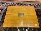 a small wooden box on a table on a rug