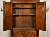 a large wooden cabinet with open doors in a room