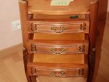 a small wooden table with a drawer on top of it