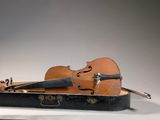 a violin and a violin case sitting on a table