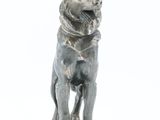 statue of a dog sitting on a marble base on a white background