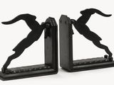 two bookends that have a silhouette of a man and a dog on them
