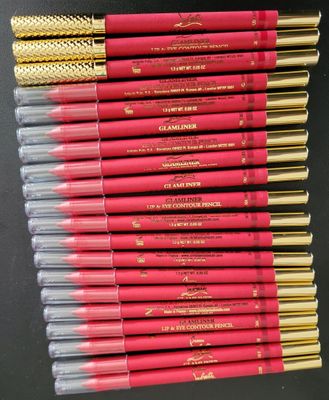 a pile of red and gold colored pencils sitting on top of each other