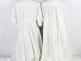 two mannequins dressed in white are standing next to each other