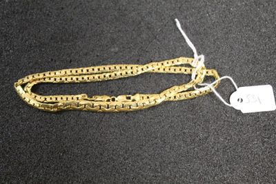 a close up of a gold chain with a tag on it