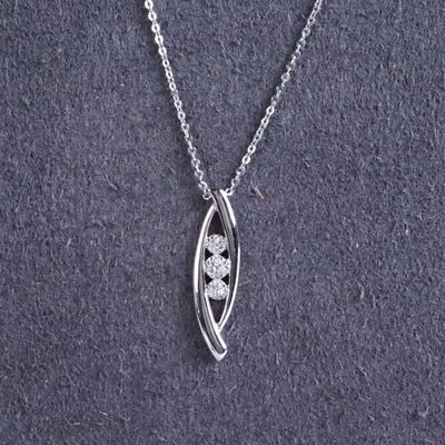 a close up of a silver necklace with a flower on it