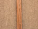 a close up of a wooden cross on a burlock cloth background