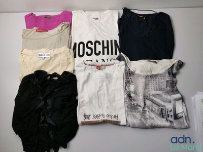 a lot of clothes that are sitting on a shelf