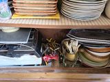 many plates and bowls stacked on a shelf in a cabinet