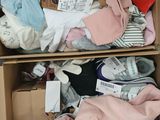 two boxes of clothes that are sitting on the floor