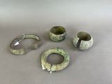 four pieces of green pottery sitting on top of a table