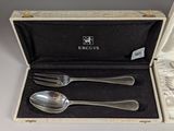 a box with a spoon and two spoons inside of it