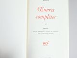 an open book with red writing on it on a gray surface