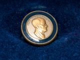 a gold coin with a picture of a man on it
