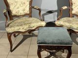 two chairs and a foot stool in a room