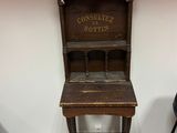 an old wooden desk with a sign on it in a room