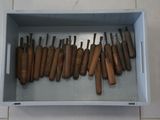 a lot of baseball bats in a box on the floor