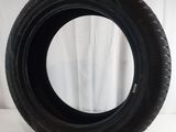 a close up of a tire on a white surface with a white curtain in the background
