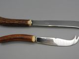 pair of two knives with wooden handles on a gray surface