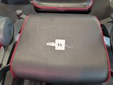 a black and red bench in a gym room