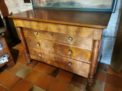 a dresser with a mirror on top of it in a room