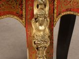 a red table with a gold decoration on it