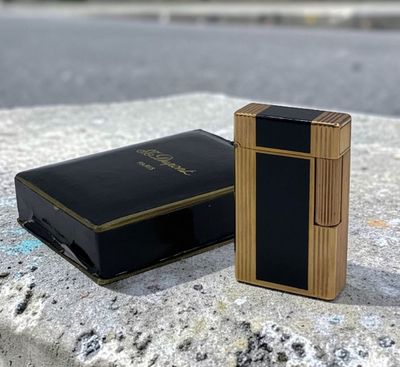a lighter that is sitting on the ground next to a box