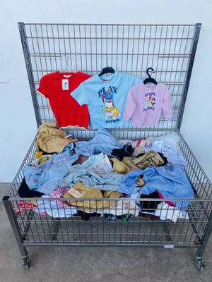 a metal cart filled with clothes and clothing items