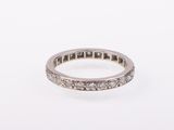 a close up of a diamond ring on a white surface