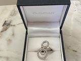 a close up of a ring in a box on a marble table