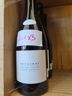 a bottle of wine that is sitting on a shelf
