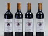 three bottles of wine are lined up on a table
