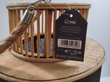 a small bird cage with a bird in it on top of a table
