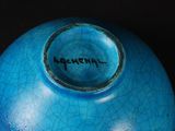 a blue vase with a cracky design on it