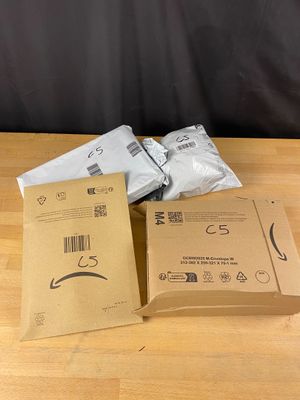 two boxes of white mail sitting on top of a wooden table