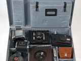 une valise ouverte contenant un appareil photo et d'autres objets