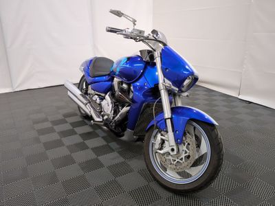 a picture of a blue motorcycle parked on a black and white checkered floor