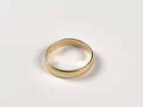 an image of a gold ring on a white surface
