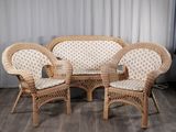 trois chaises en osier et une table dans une pièce avec un rideau blanc