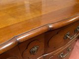 an image of a wooden chest of drawers in a room