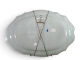 a large white plate with a pair of scissors on it