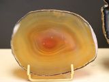 a yellow agate sitting on a table next to a black and white agate