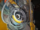 a yellow and black machine with a hose and other tools in it