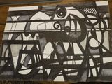 a black and white drawing on a piece of paper on a table