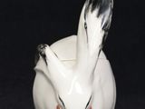 an image of a white rabbit figurine sitting on top of a black surface