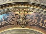 a close up of a clock with a decorative design on it