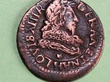 an old copper coin with a picture of a man on it