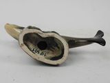 a small pipe with a heart on it on a white surface