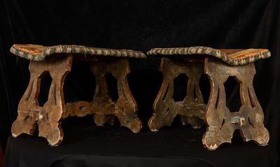 two wooden benches that are sitting on a black table