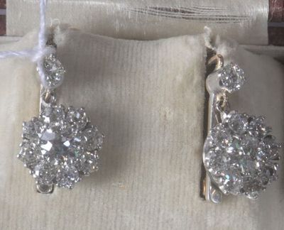 a pair of earrings that are sitting in a box